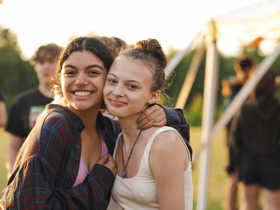 Two campers hug during an activity.